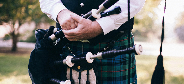 Scottish man wearing a tartan kilt.