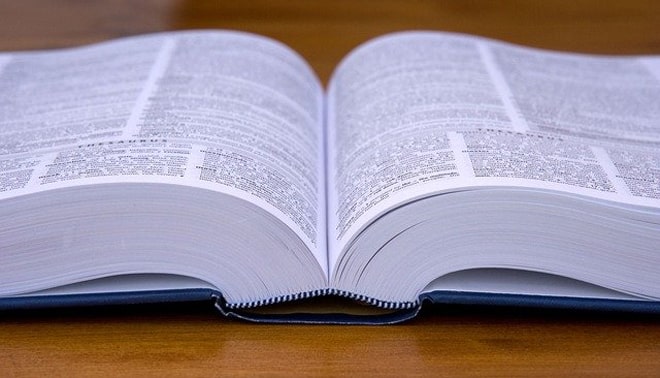 A glossary lying open on a wooden table.