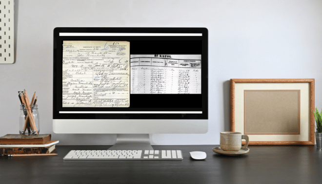Home office with a desktop computer displaying two types of genealogy records.