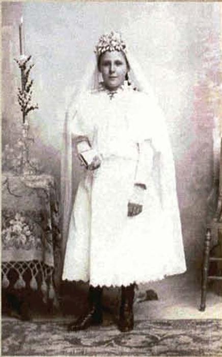 Black and white photo of an ancestor dressed for a first communion.