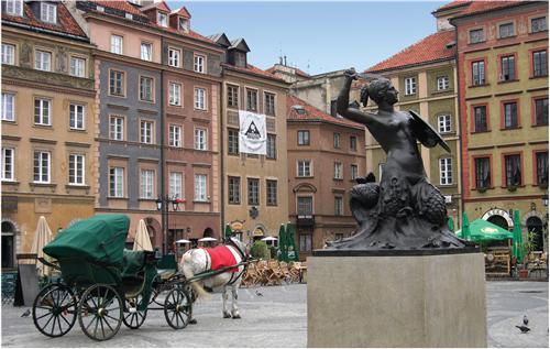 Polish city square with a horse-drawn carriage.