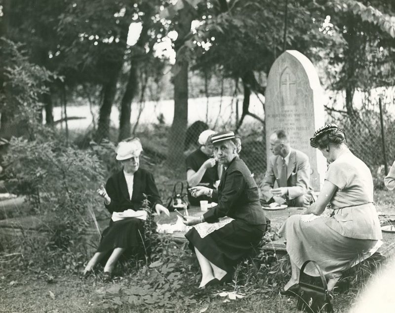 Family having a picnic in a cemetery 