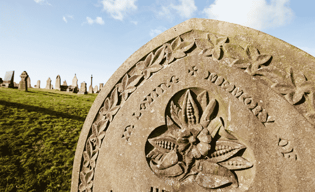Flower symbols engraved in a gravestone.