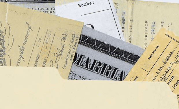 File folder with various vital records documents spilling out.