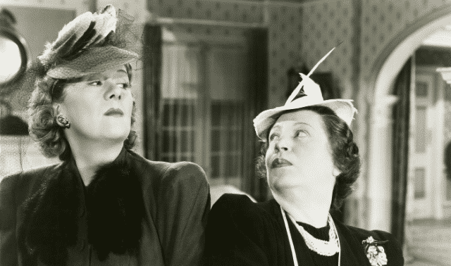 Black-and-white photo of two women in period dress