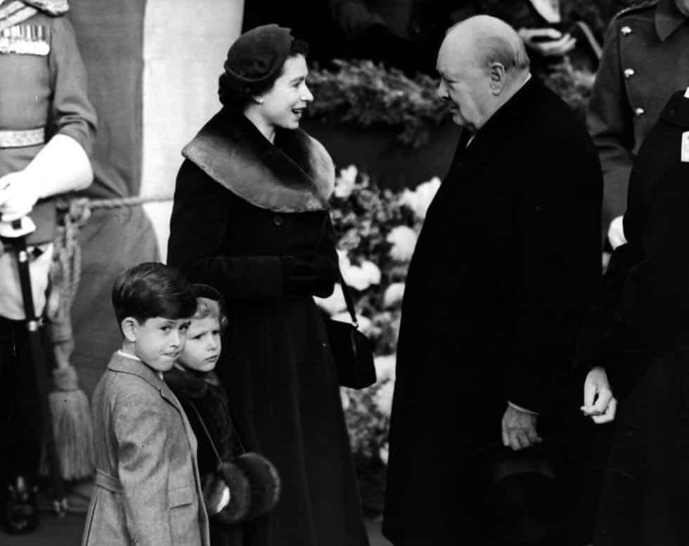 Queen Elizabeth speaking to Winston Churchill in 1953. The young Prince Charles and Princess Anne are also present.