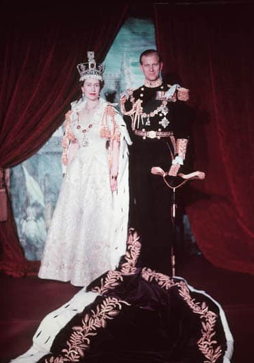 Queen Elizabeth II and Prince Phillip pose after the Queen's coronation. The Queen wears St. Edward's Crown and her coronation dress; Phillip wears his military uniform.
