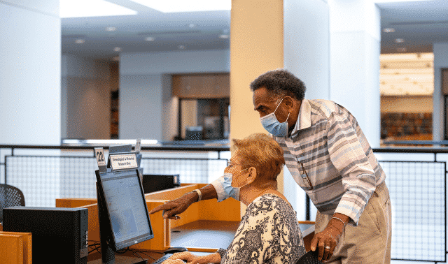 Librarian helping patron with her genealogy at the Allen County Public Library in Fort Wayne, Indiana