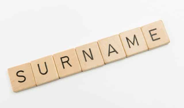 Wooden letter tiles spelling out "surname"