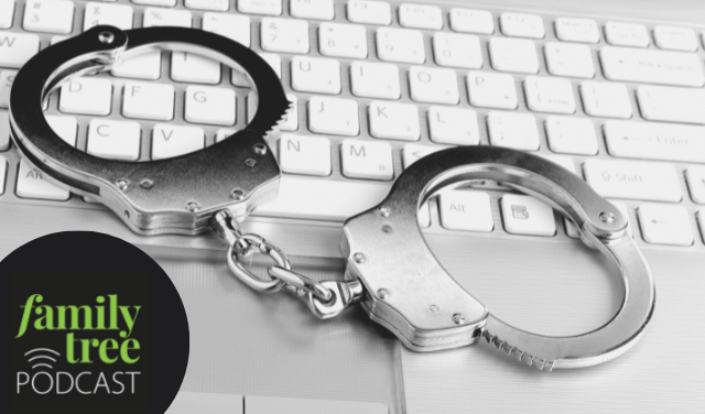 Pair of handcuffs resting on a computer keyboard.